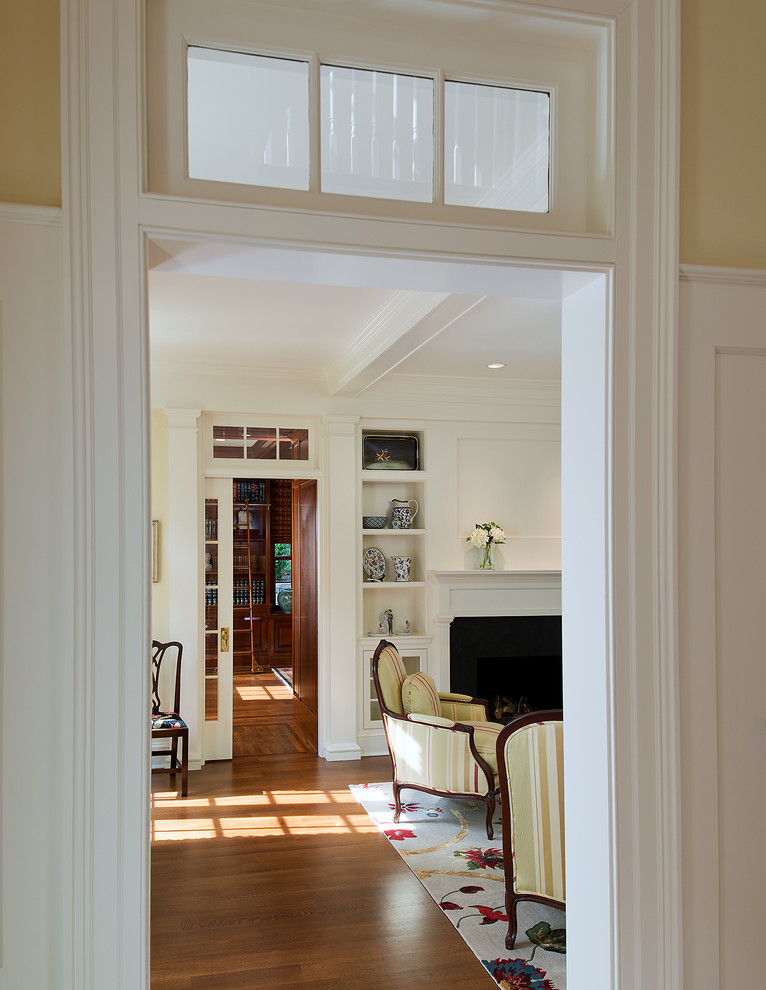 Mid-sized traditional hallway in DC Metro with white walls and dark hardwood floors.