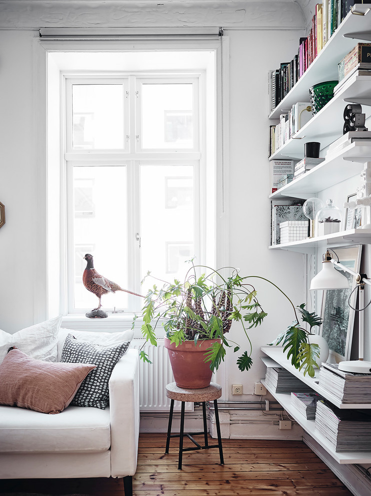 Inspiration for a scandinavian living room in Gothenburg with white walls, medium hardwood floors and brown floor.