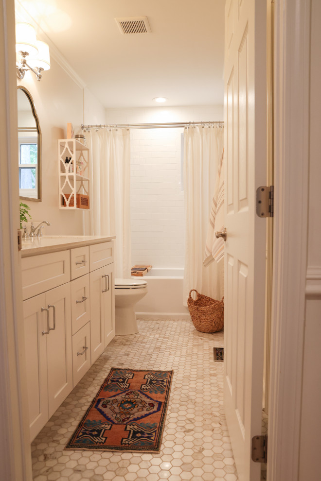 Inspiration for a mid-sized traditional bathroom in Atlanta with shaker cabinets, white cabinets, a drop-in tub, a shower/bathtub combo, a two-piece toilet, white tile, ceramic tile, white walls, ceramic floors, an undermount sink, engineered quartz benchtops, white floor, a shower curtain, yellow benchtops, a double vanity and a built-in vanity.