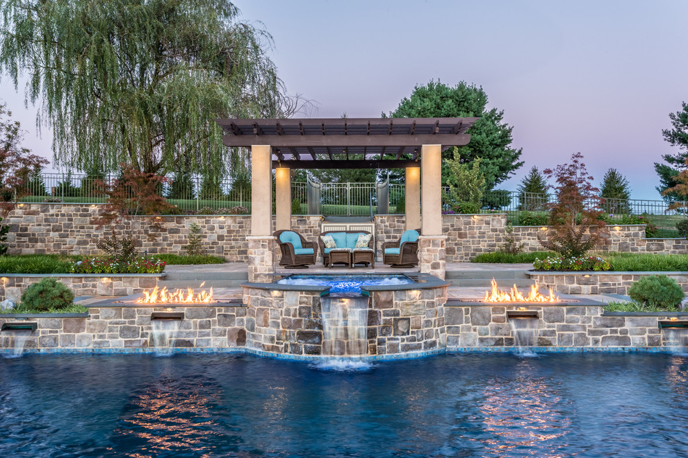 Inspiration for a large traditional backyard custom-shaped lap pool in Other with a hot tub and concrete pavers.