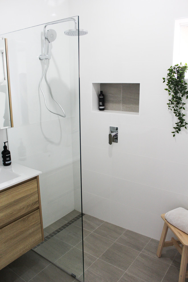 Inspiration for a small 3/4 bathroom in Perth with flat-panel cabinets, dark wood cabinets, an open shower, a one-piece toilet, white tile, ceramic tile, white walls, porcelain floors, a vessel sink, solid surface benchtops, grey floor, an open shower and white benchtops.