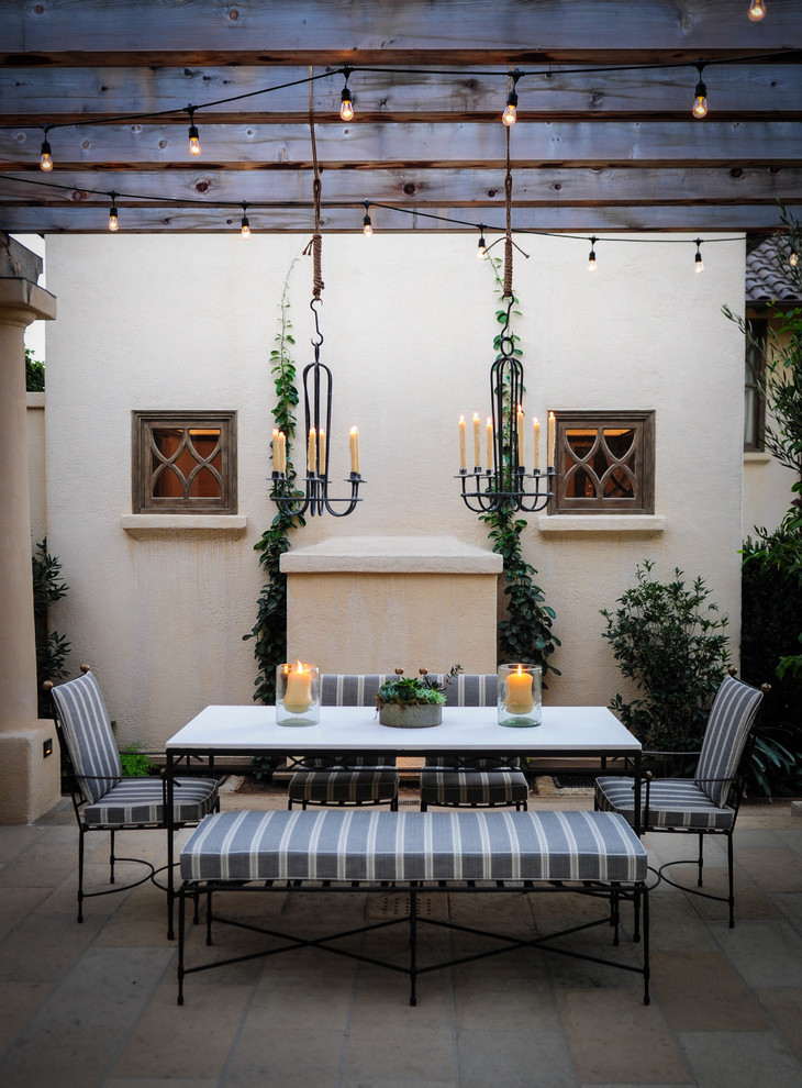 This is an example of a mediterranean patio in Santa Barbara with a pergola.