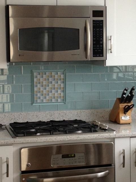 Inspiration for a transitional u-shaped vinyl floor eat-in kitchen remodel in Boston with recessed-panel cabinets, white cabinets, granite countertops, blue backsplash, mosaic tile backsplash, stainless steel appliances and no island