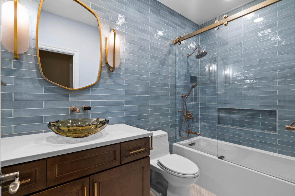 Photo of a bathroom in Seattle with a freestanding bath, a shower/bath combination, a one-piece toilet, blue tiles, ceramic tiles, mosaic tile flooring, white floors, a sliding door, white worktops, a single sink, a freestanding vanity unit and a wood ceiling.