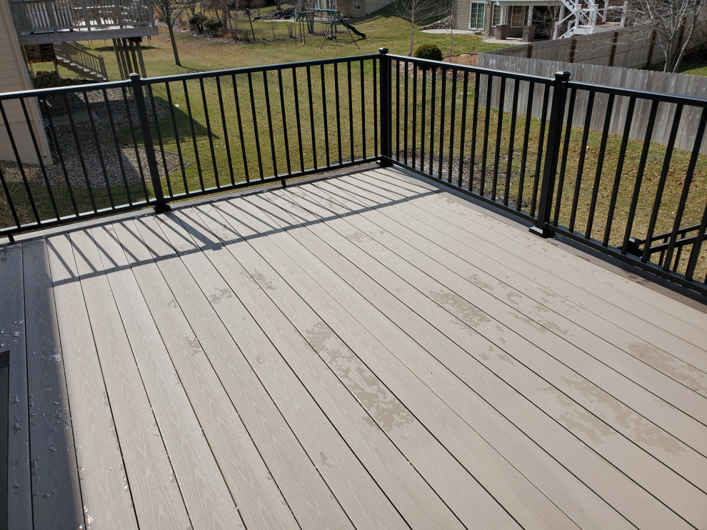 Example of a mid-sized backyard second story metal railing deck design with no cover