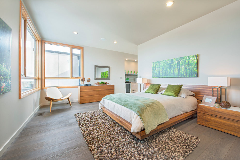 Inspiration for a contemporary bedroom in Calgary with grey walls and dark hardwood floors.