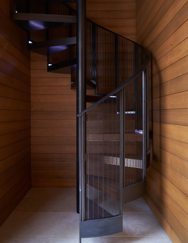 Inspiration for a small modern wood spiral metal railing staircase in Salt Lake City with open risers and wood walls.