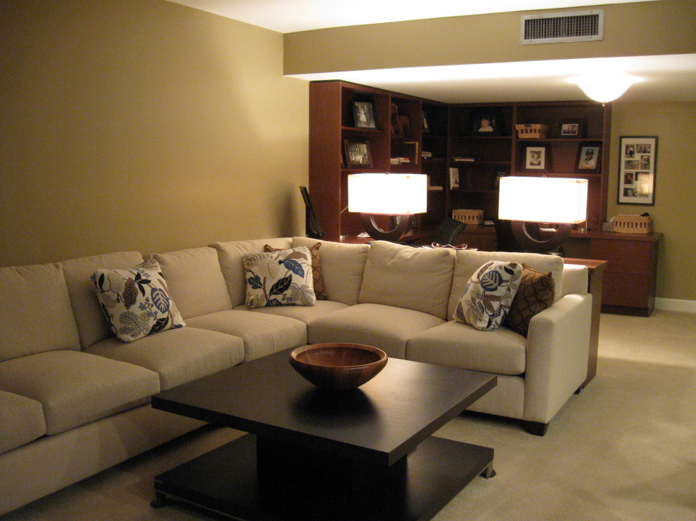 This is an example of a mid-sized contemporary home office in Miami with beige walls, carpet and a freestanding desk.
