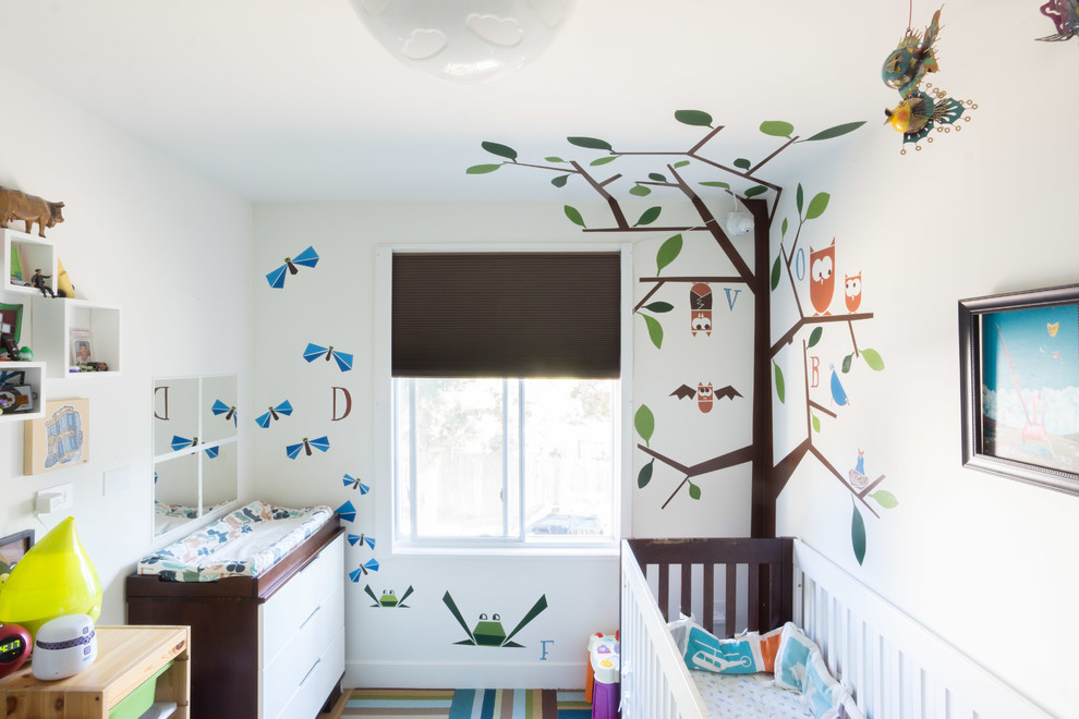 Photo of a small contemporary gender-neutral nursery in San Francisco with multi-coloured walls.
