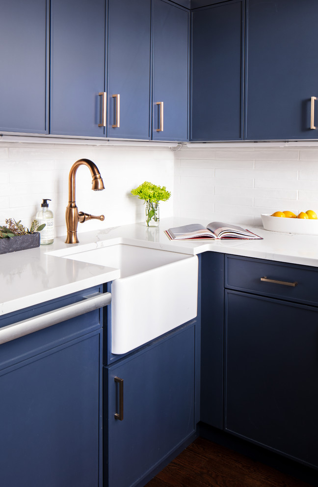 Inspiration for a small transitional dark wood floor and brown floor kitchen remodel in New York with a farmhouse sink, blue cabinets, white backsplash, ceramic backsplash, colored appliances and no island