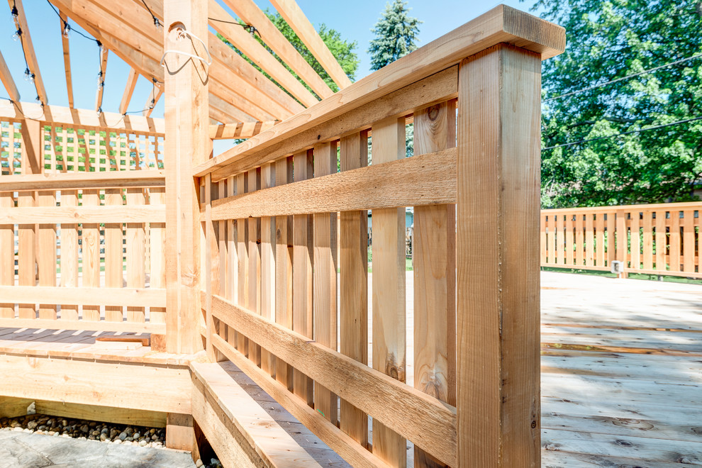 Inspiration for a large transitional backyard deck remodel in Chicago with a pergola