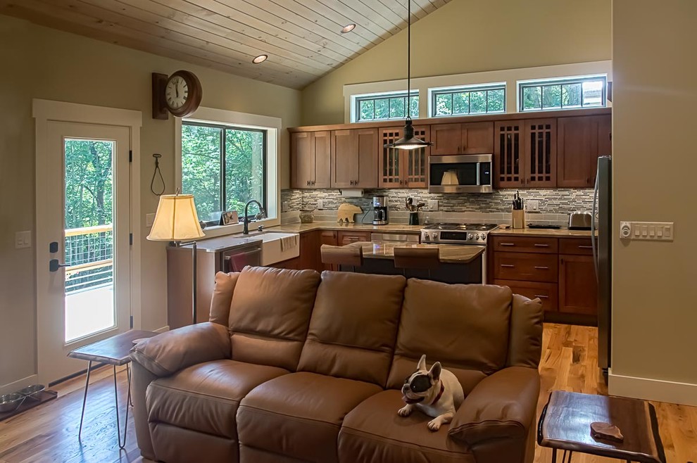 Mid-sized transitional u-shaped medium tone wood floor and brown floor eat-in kitchen photo with a farmhouse sink, shaker cabinets, medium tone wood cabinets, granite countertops, glass tile backsplash, stainless steel appliances, an island, beige backsplash and beige countertops