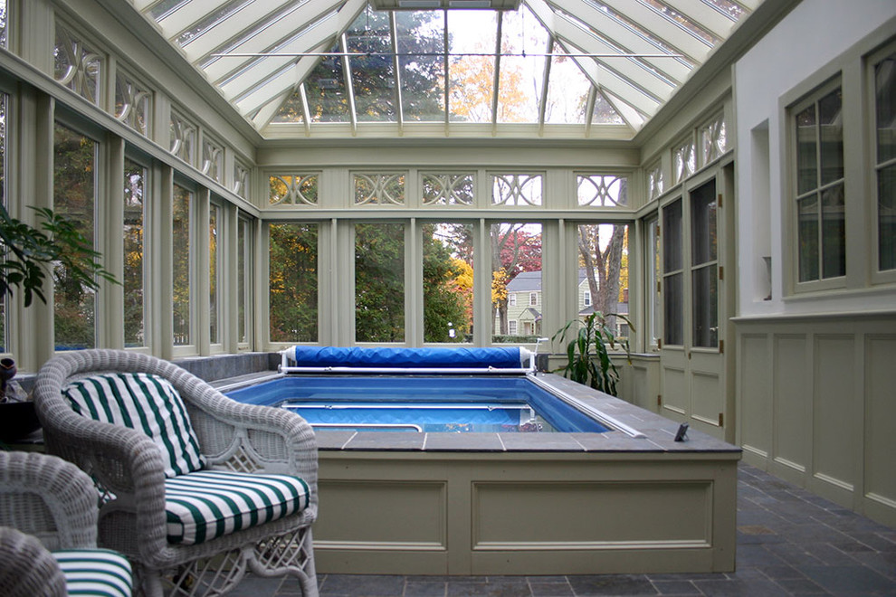Design ideas for a small traditional indoor rectangular aboveground pool in Other with a pool house and natural stone pavers.