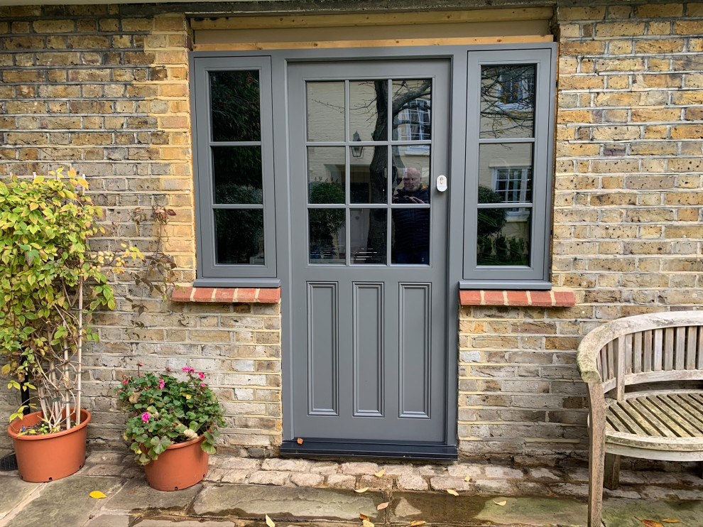 Design ideas for a traditional front door in Hampshire with a single front door and a gray front door.