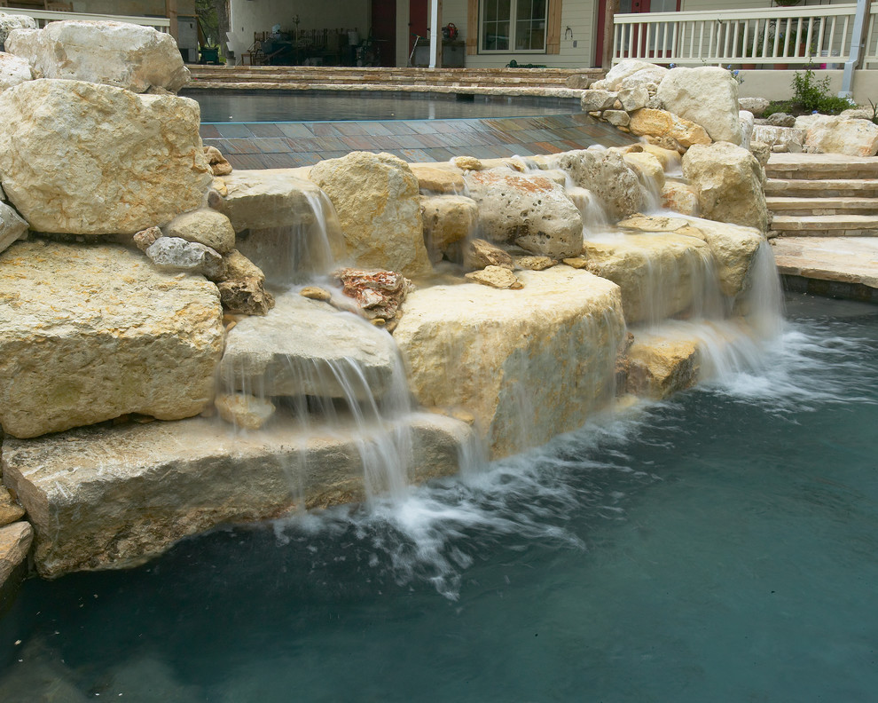Large mountain style courtyard concrete and custom-shaped natural pool fountain photo in Austin