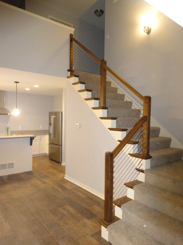 Example of a mid-sized transitional carpeted l-shaped staircase design in Milwaukee with carpeted risers