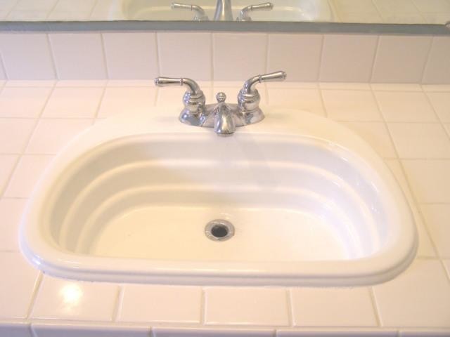 Bathroom - white tile bathroom idea with a drop-in sink