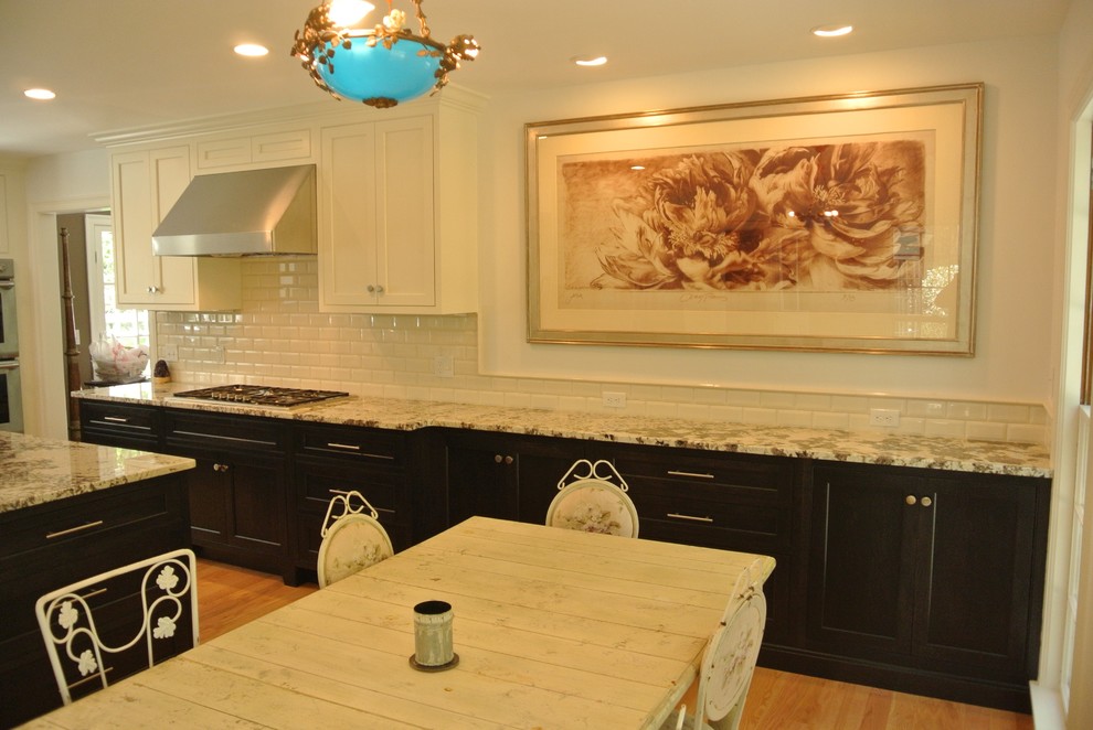 Eat-in kitchen - transitional light wood floor eat-in kitchen idea in Boston with shaker cabinets, granite countertops, white backsplash, subway tile backsplash, stainless steel appliances, an island and an undermount sink