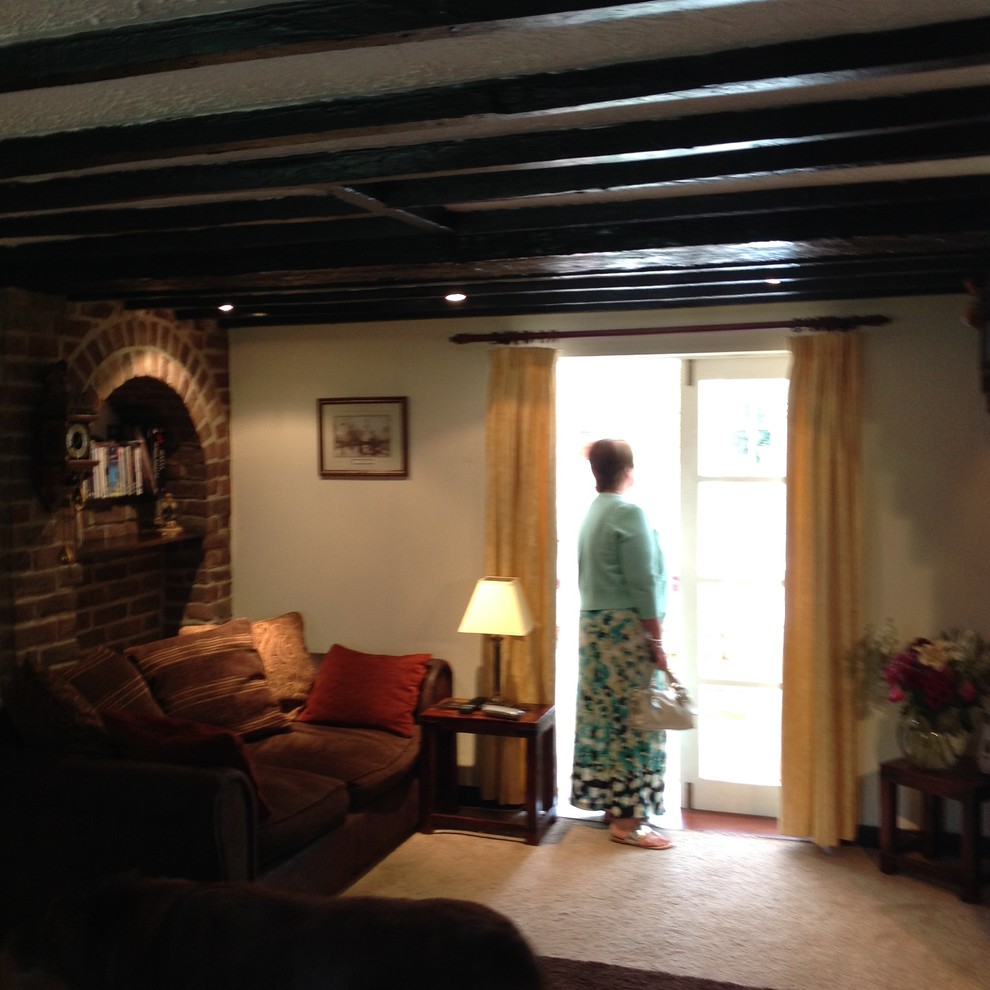 How to lighten a cottage with small windows and black wooden beams