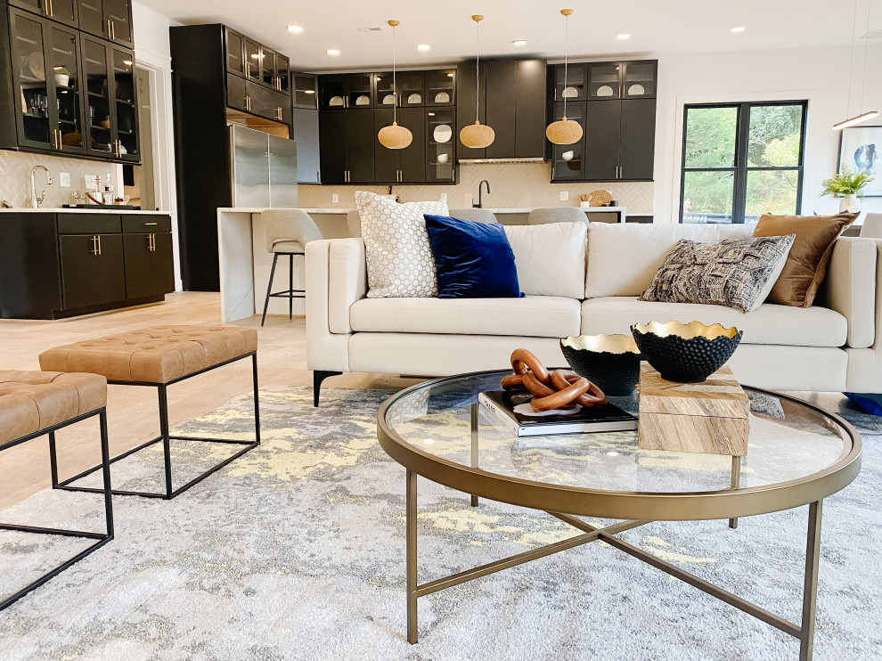 Photo of an expansive transitional open concept living room in DC Metro with a home bar, white walls, light hardwood floors, a ribbon fireplace, a tile fireplace surround, no tv and beige floor.
