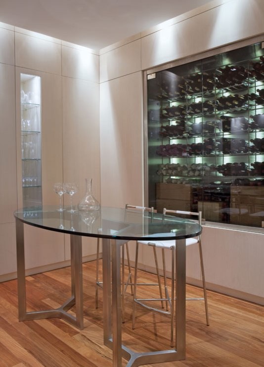 This is an example of a mid-sized contemporary wine cellar in Other with display racks.