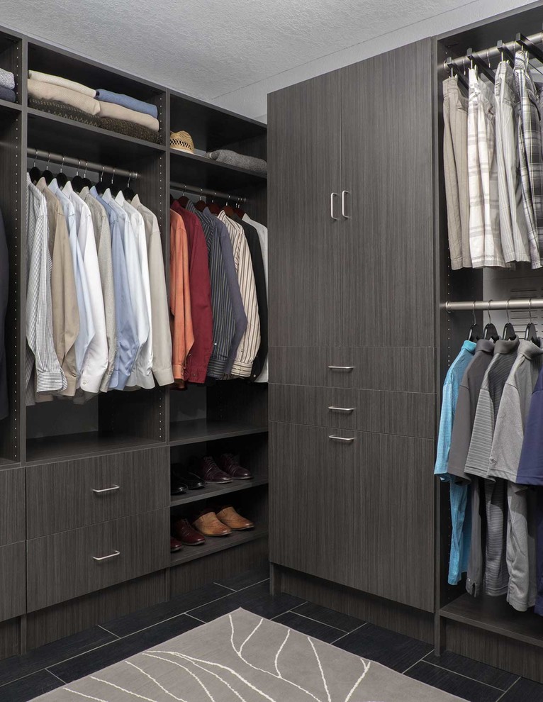 Mid-sized modern men's walk-in wardrobe in Phoenix with flat-panel cabinets, grey cabinets and porcelain floors.