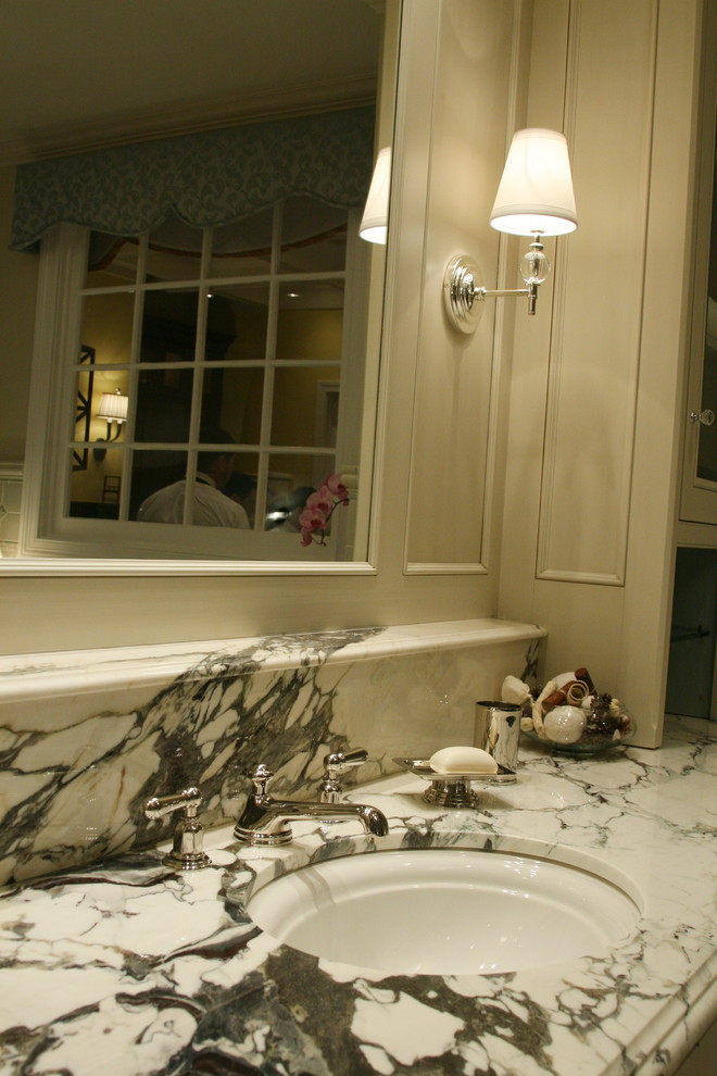 Inspiration for a large transitional master gray tile bathroom remodel in Chicago with recessed-panel cabinets, distressed cabinets, marble countertops and an undermount sink