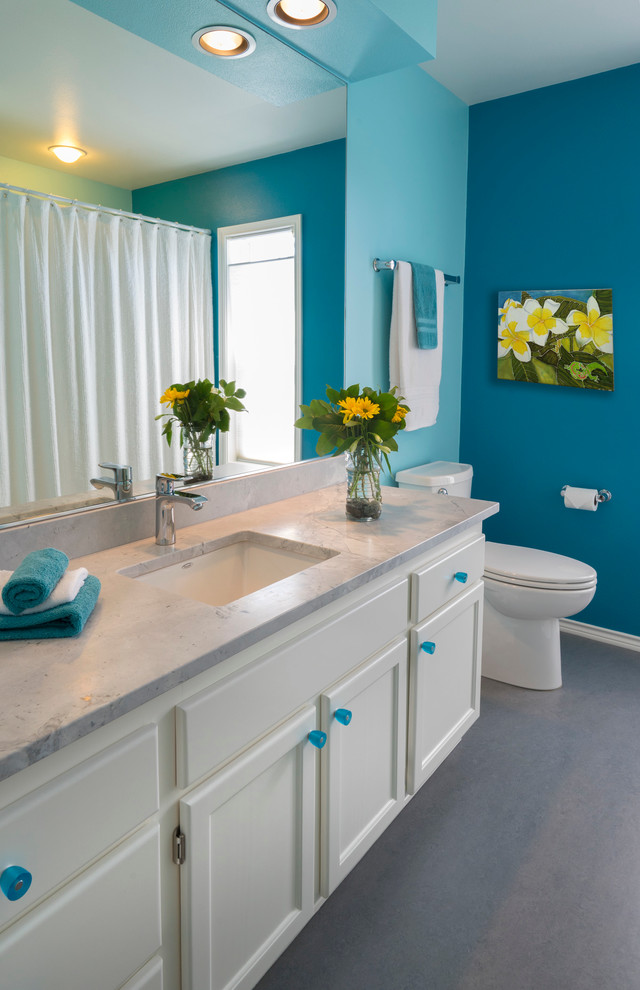 This is an example of an eclectic bathroom in Portland with blue walls and linoleum floors.