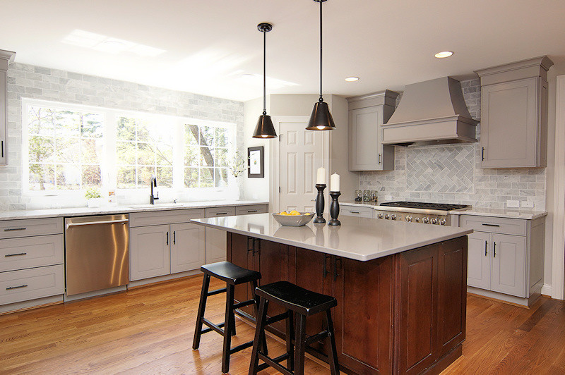 Kitchen - large transitional medium tone wood floor kitchen idea in Cincinnati with shaker cabinets, gray cabinets, marble countertops, white backsplash, stone tile backsplash, stainless steel appliances, beige walls and an island