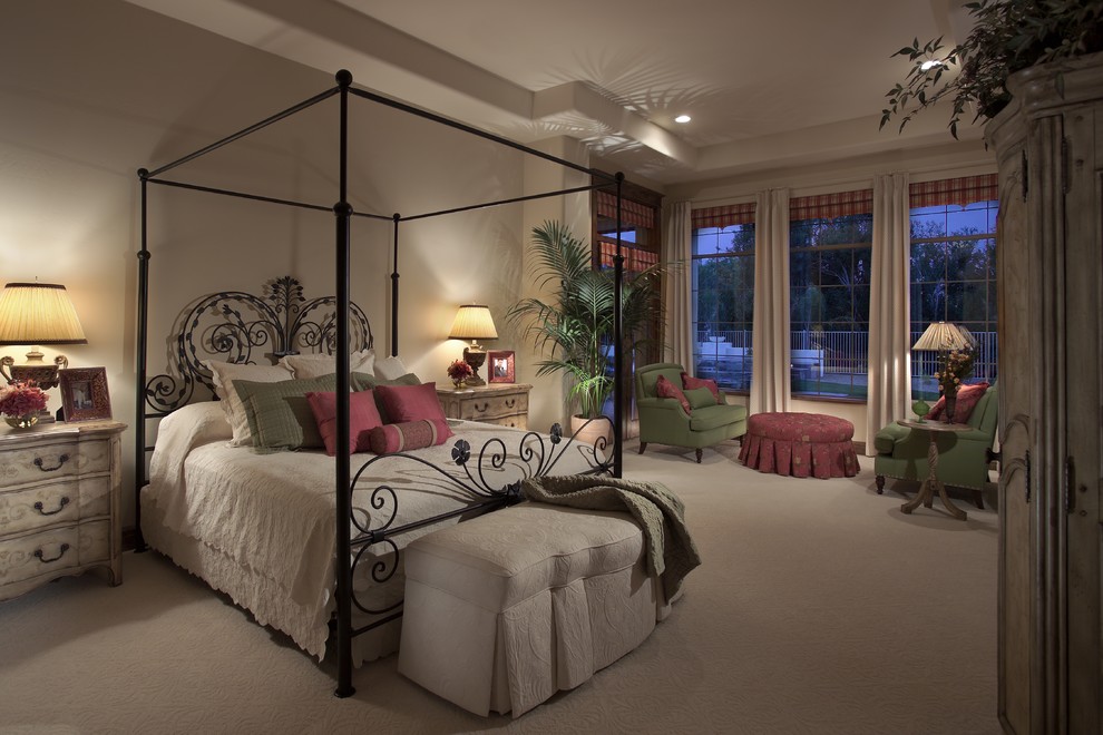 Mediterranean bedroom in Phoenix with beige walls and carpet.