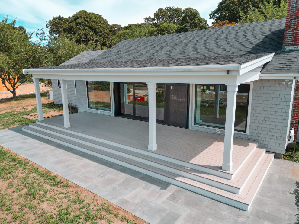 Example of a white one-story brick gable roof design with a shingle roof and a gray roof