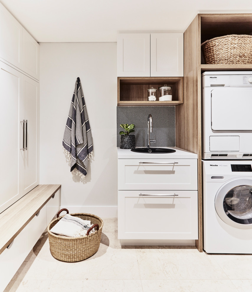 This is an example of a beach style laundry room in Sydney.