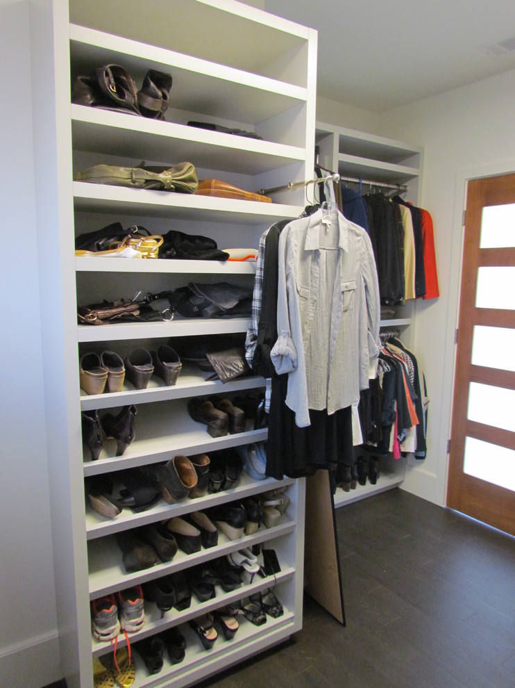 This is an example of a mid-sized contemporary women's walk-in wardrobe in Atlanta with grey cabinets and dark hardwood floors.