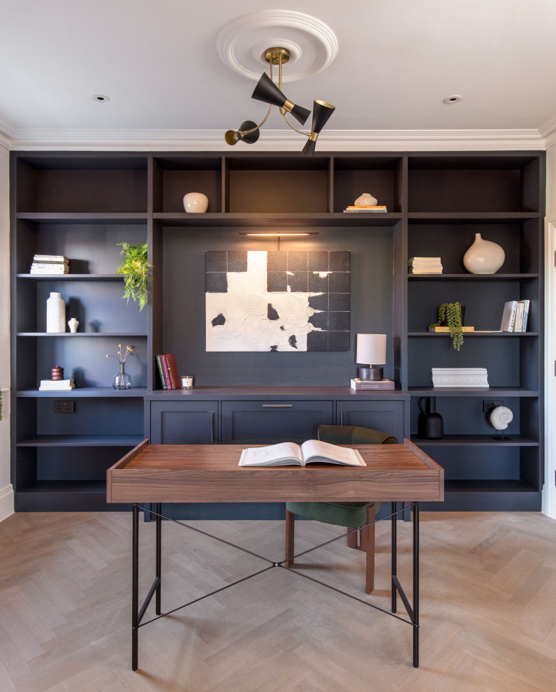 Photo of a medium sized traditional study in Hertfordshire with blue walls, light hardwood flooring, a freestanding desk and beige floors.