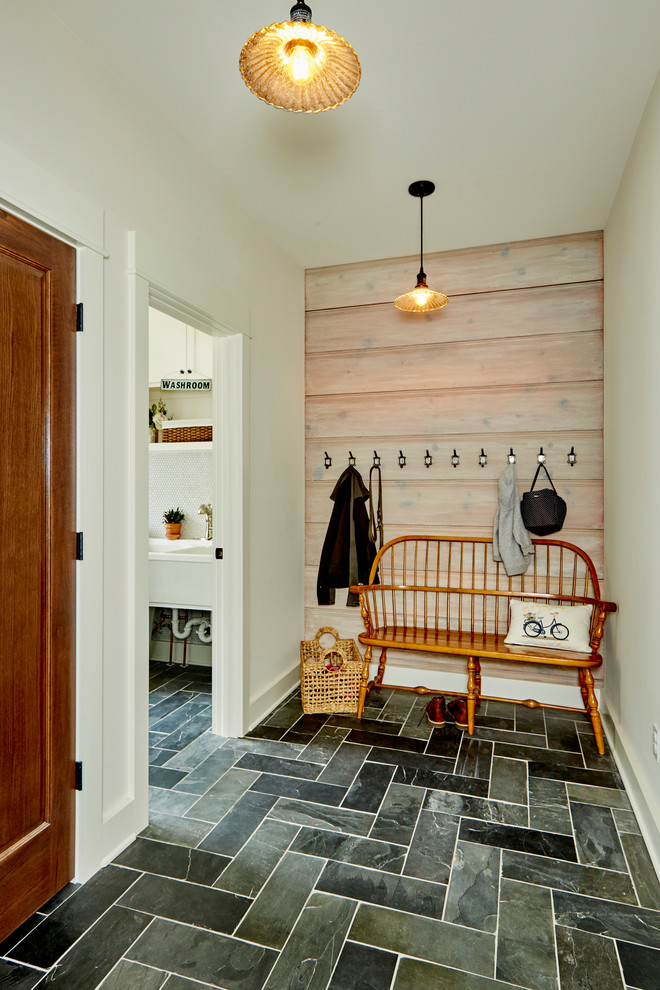 Design ideas for a country mudroom in Milwaukee with white walls, slate floors and grey floor.