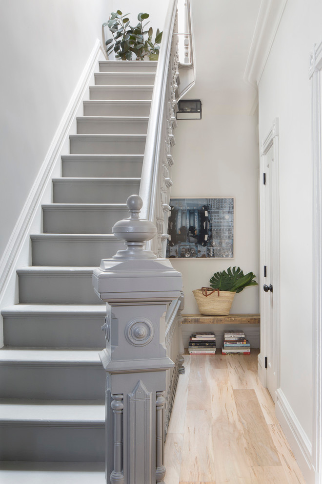 Photo of a mid-sized transitional painted wood l-shaped staircase in New York with painted wood risers and wood railing.