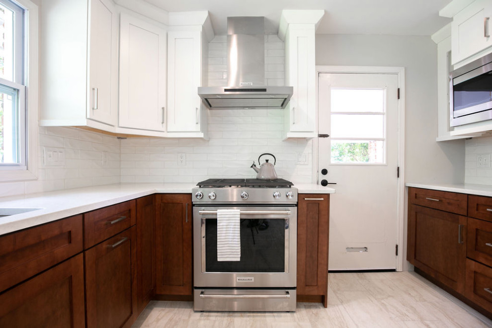 Example of a transitional kitchen design in Atlanta with white cabinets