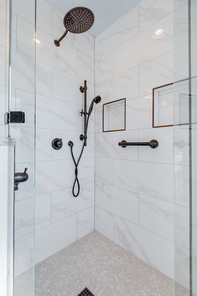 Contemporary master bathroom in Nashville with white cabinets, a corner shower, white tile, marble, white walls, marble floors, an undermount sink, white floor and a hinged shower door.