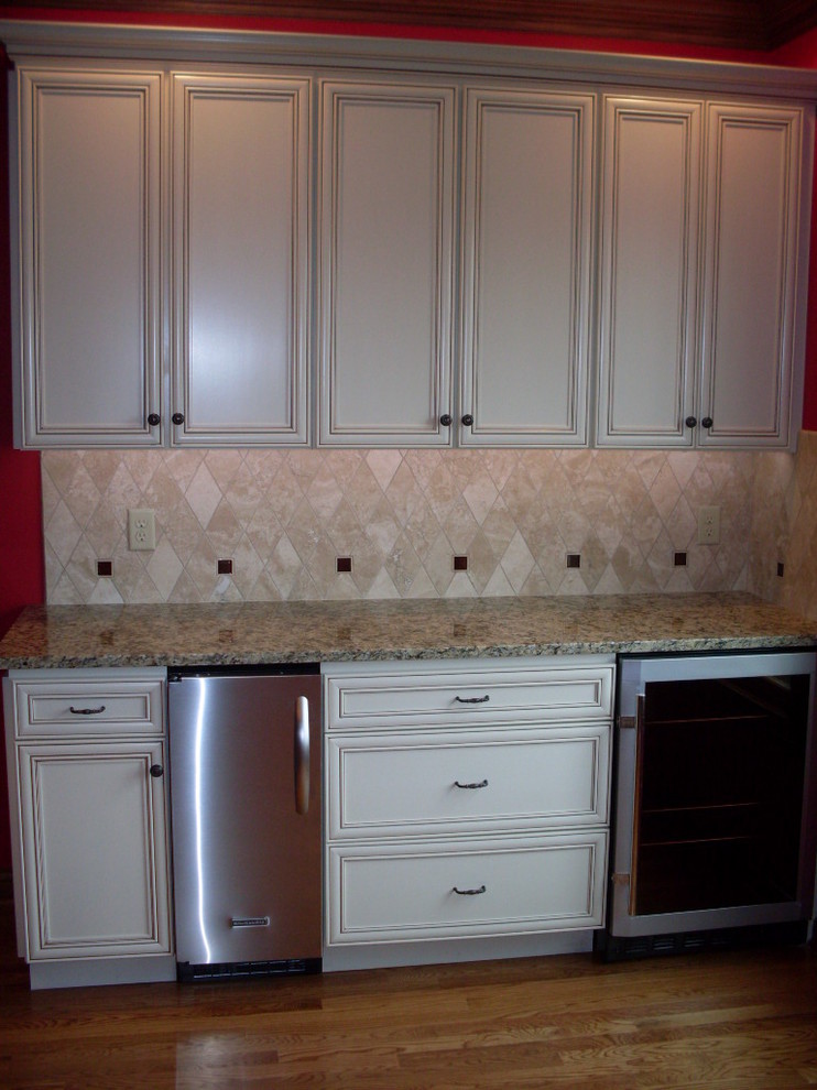 Open concept kitchen - mid-sized transitional u-shaped dark wood floor open concept kitchen idea in Cincinnati with an undermount sink, recessed-panel cabinets, white cabinets, granite countertops, beige backsplash, ceramic backsplash, stainless steel appliances and an island