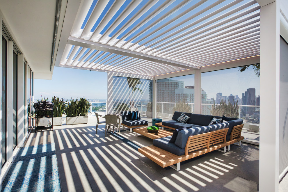 Example of a mid-sized beach style rooftop rooftop metal railing deck design in Miami with a pergola
