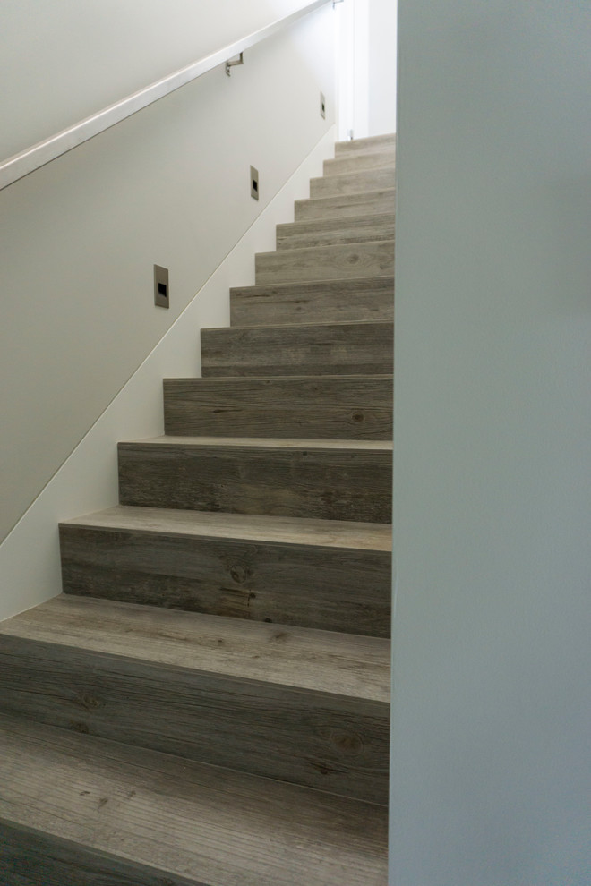 Photo of a mid-sized country wood straight staircase in San Diego with wood risers and metal railing.