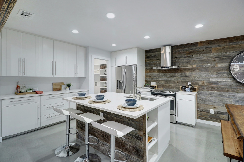 Design ideas for a contemporary l-shaped eat-in kitchen in Austin with flat-panel cabinets, white cabinets, timber splashback, stainless steel appliances, with island, an undermount sink, concrete floors and grey floor.