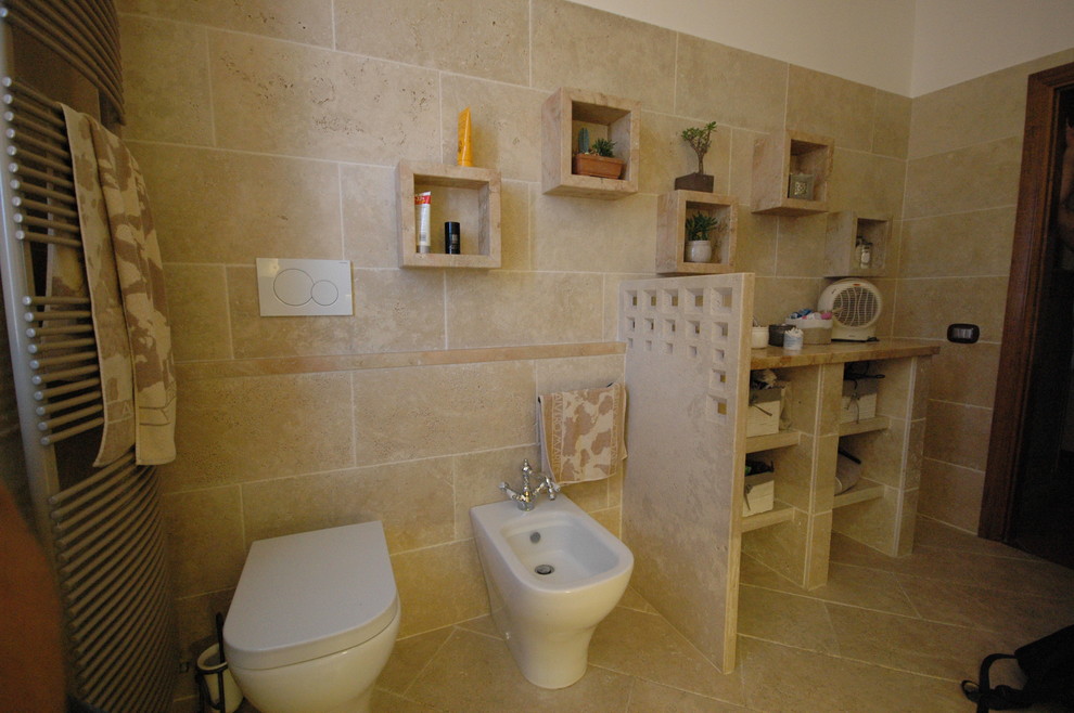 Mid-sized contemporary 3/4 bathroom in Other with open cabinets, beige cabinets, a curbless shower, a two-piece toilet, beige tile, travertine, beige walls, travertine floors, a vessel sink, limestone benchtops, beige floor and a sliding shower screen.