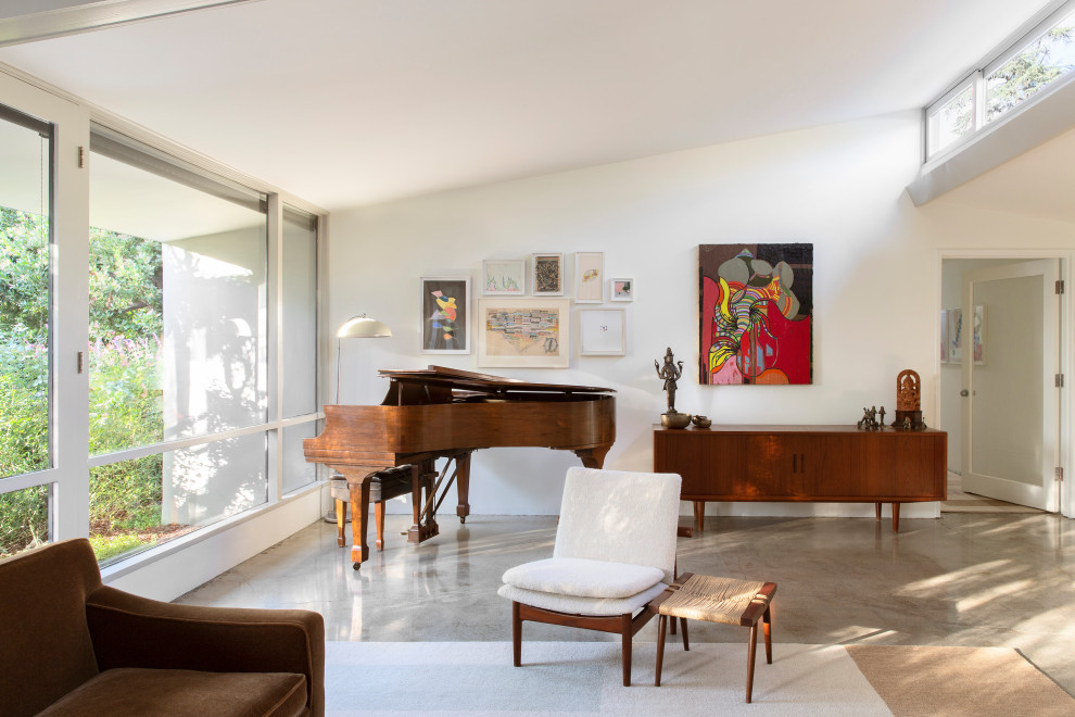 Example of a mid-sized 1960s living room design in Los Angeles with white walls, a standard fireplace and a brick fireplace