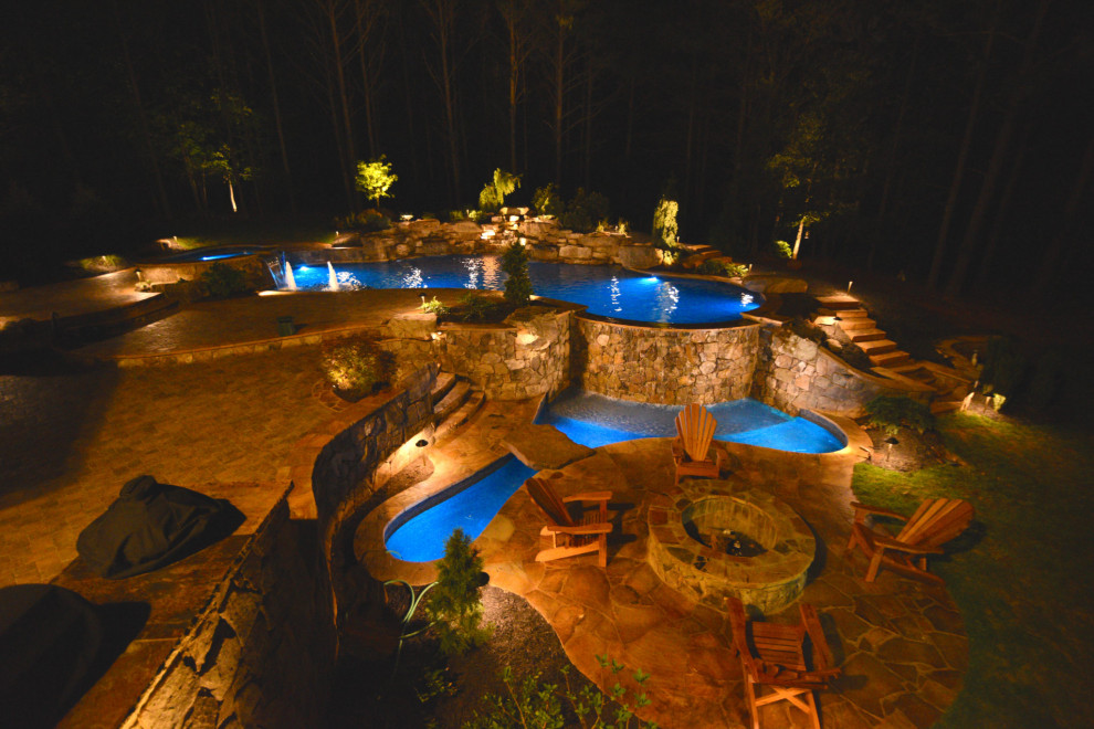 Photo of a large classic back custom shaped natural swimming pool in Atlanta with with pool landscaping.