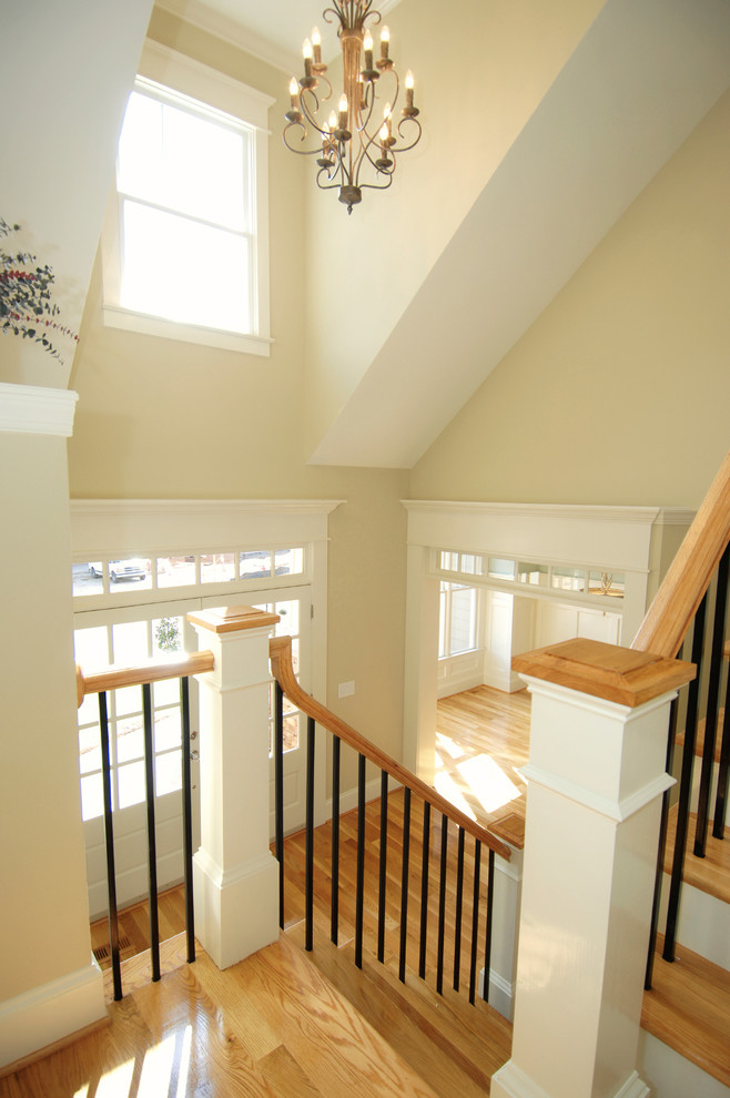 Example of a mid-sized transitional wooden u-shaped wood railing staircase design in Toronto with wooden risers