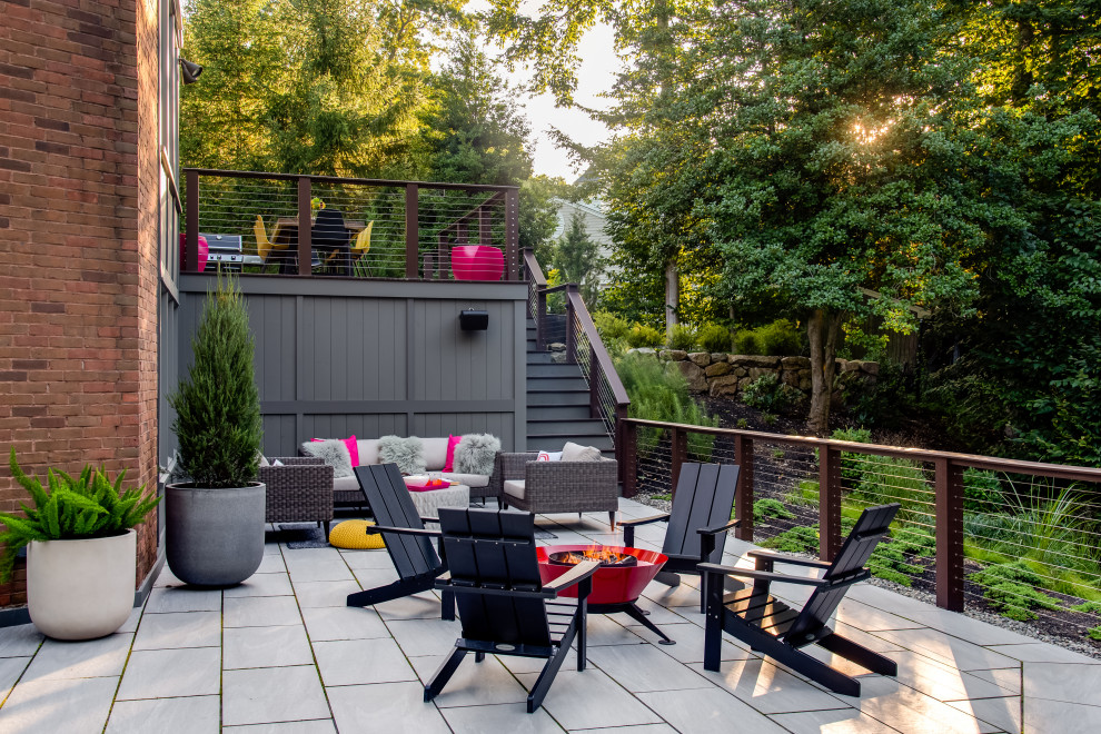 Design ideas for a midcentury patio in Boston with a fire feature and concrete pavers.