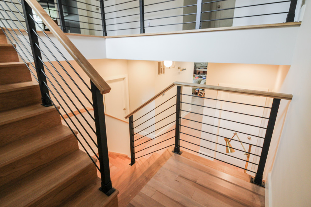 Photo of a large modern wood straight staircase in DC Metro with wood risers and mixed railing.
