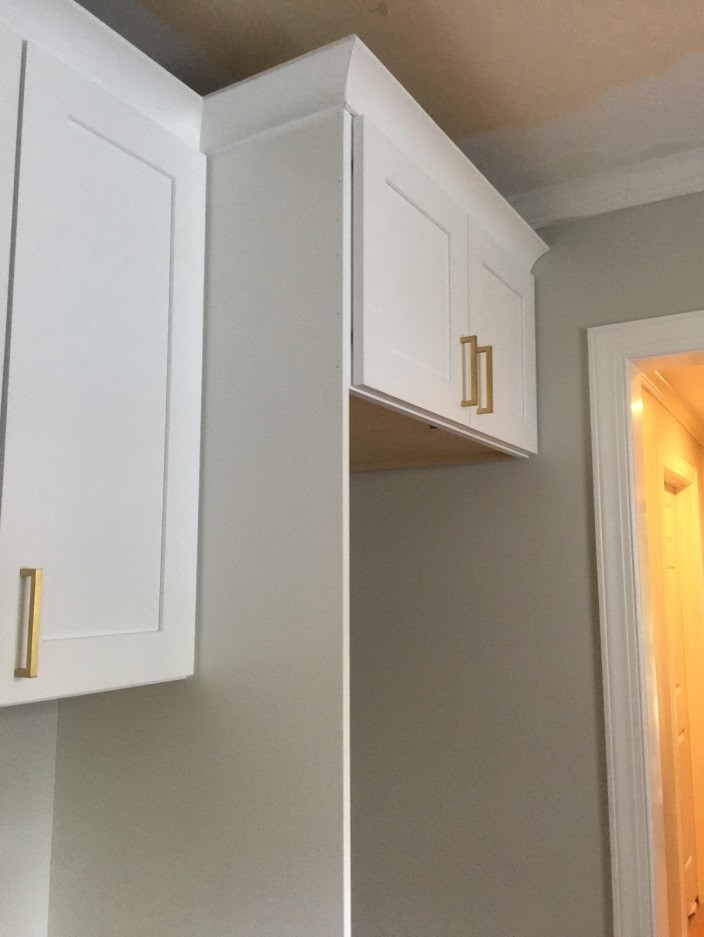 Cabinets will touch the ceiling, we have two piece crown dont