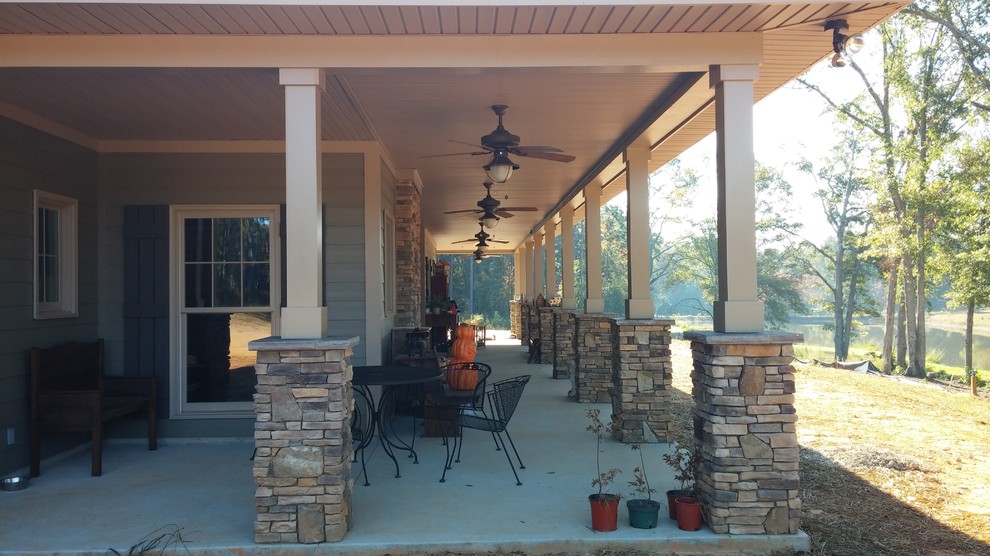 Large traditional backyard verandah in Atlanta with concrete slab and a roof extension.